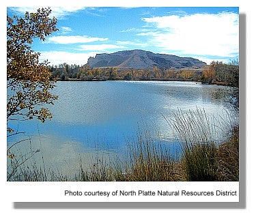 Picture of a lake with a large hill in the background