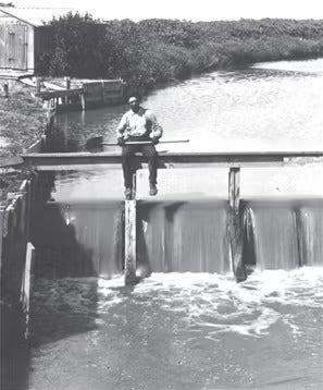 Man sitting over small waterfall
